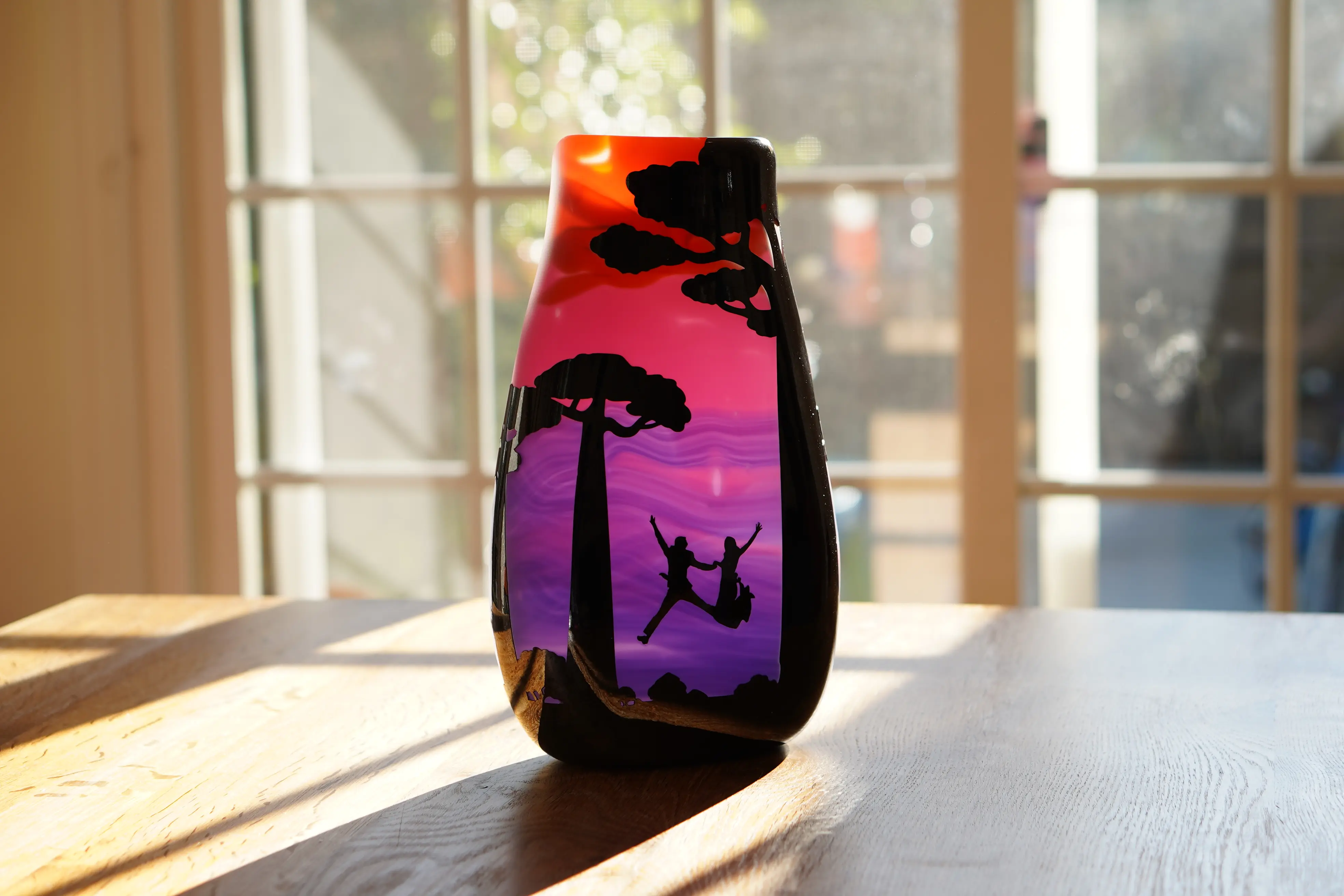 Madagascar Wedding Graal glass vase outdoors on a wooden table