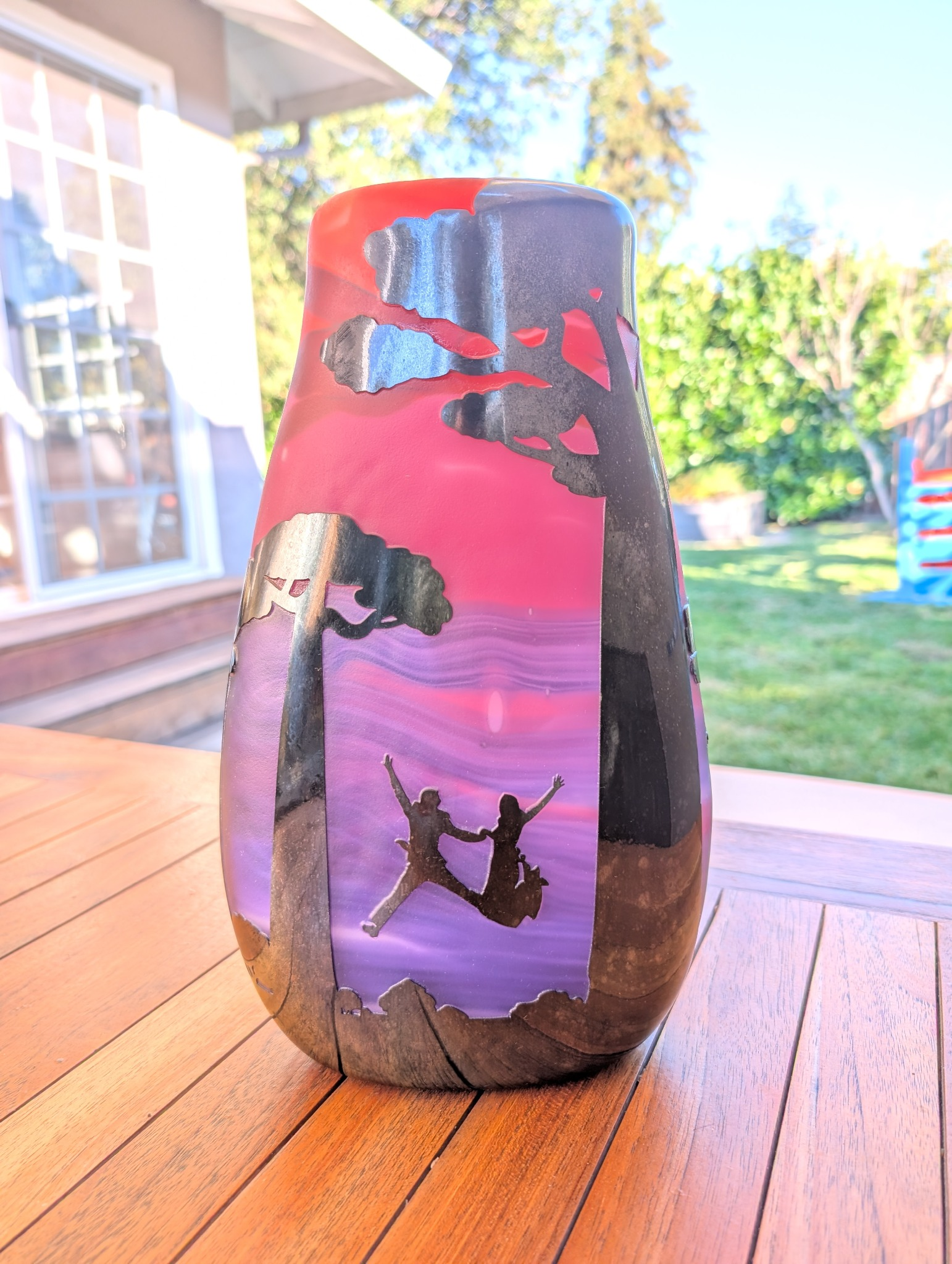 Madagascar Wedding Graal glass vase outdoors on a wooden table